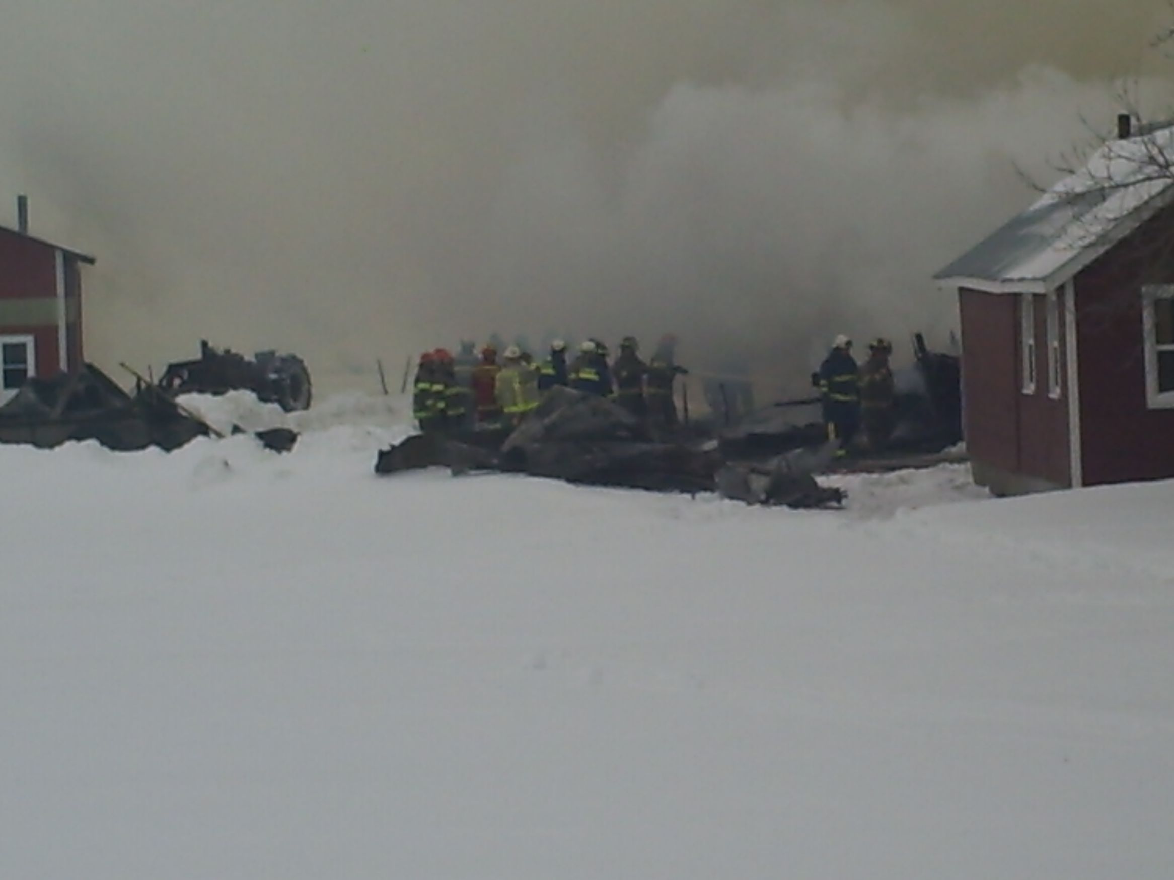 Fire Fighters wetting down the barn