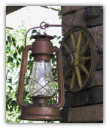 A A Old Time Wagon Wheel Sconce With Lantern