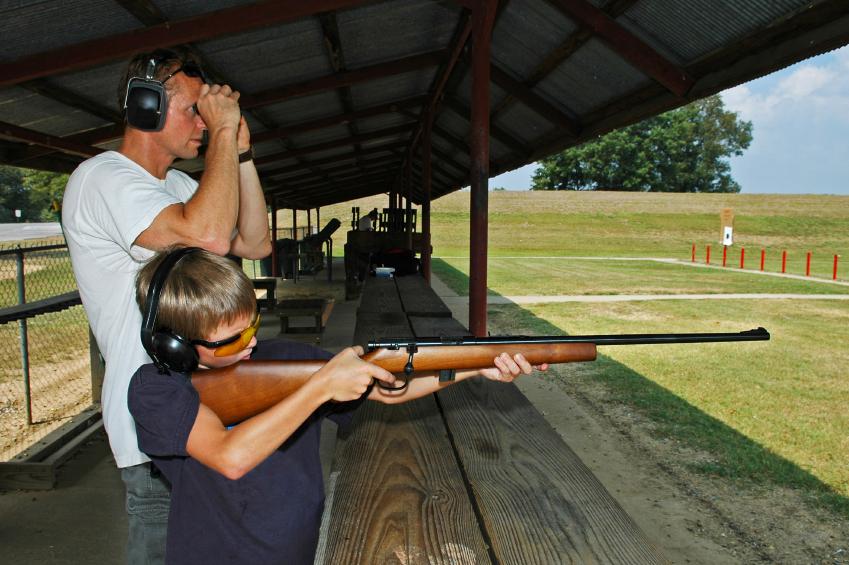 Father target shooting sabot reloaded ammo with son.