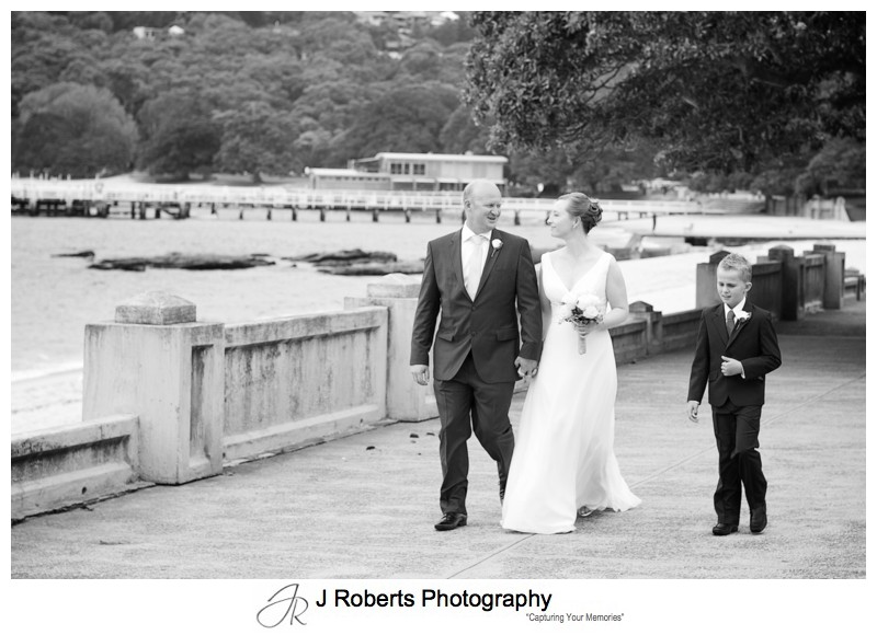 Couple and son walking along the Esplanade Balmoral - wedding photography sydney